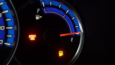 The fuel gauge on a dashboard of a car reads as empty.
