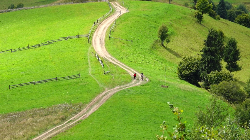 Tourists walk along a mountain road in the Carpathians.