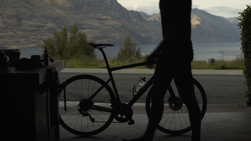 Silhouette of healthy male cyclist wearing safety helmet before his cycling training The Remarkables South Island Otago New Zealand
