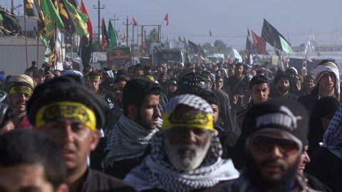 KARBALA, IRAQ - DEC 2015: Crowd of pilgrims walking in Arbaeen pilgrimage. Every year, millions of Shiite muslims come from all over the world to Karbala to walk Arbaeen