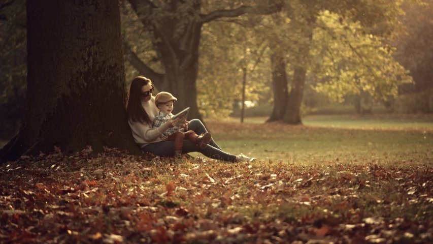 Mum and son hugging and playing in a park