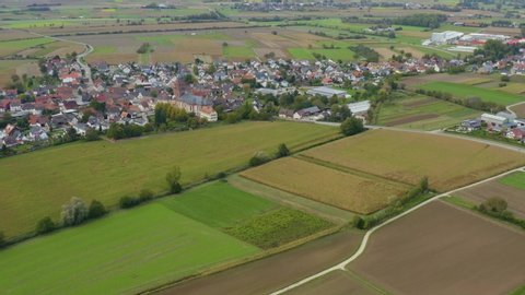 Aerial view of the village Schuttern in Germany. On a cloudy day in Autumn. Zoom in on the village.