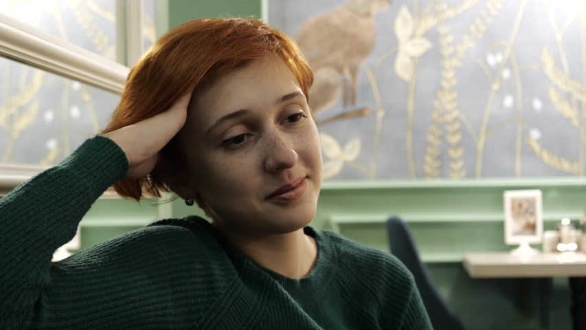 Cute woman dream in thoughts closeup sitting cafe background with smile 4K. Woman imagination thoughts coast for new inspiration creativity. Girl pleasant dream of first love in relaxing environment.