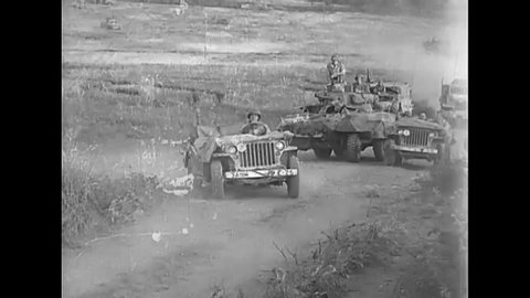 CIRCA 1944 - US Army tanks, cars, and jeeps drive up a road towards Rome in World War Two..