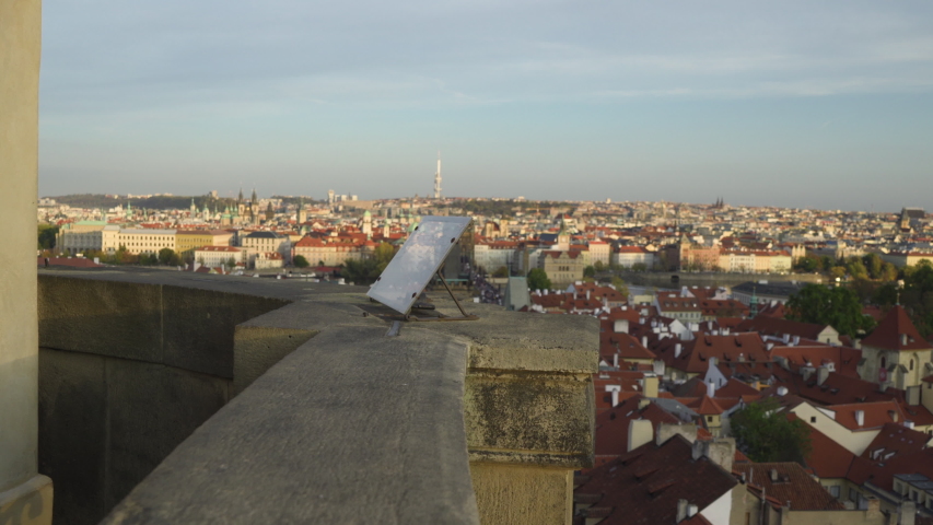 Happy man start fresh new life looking at Prague centre and Charles Bridge view from above and using phone to take a panorama photo - Professional stabilized shot - Czech Republic