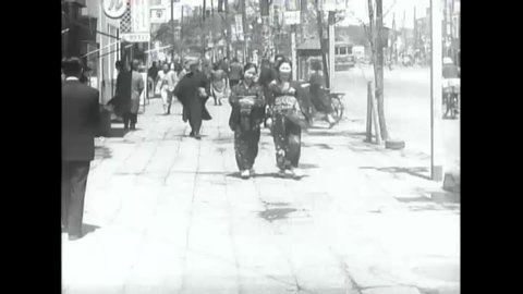 CIRCA 1950s - Busy city streets with many pedestrians and merchants, Tokyo 1951