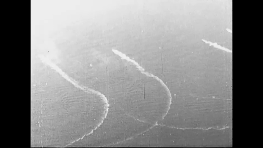 CIRCA 1926 - US Navy torpedo planes follow burning cruisers during a war games exercise. Torpedoes are dropped.