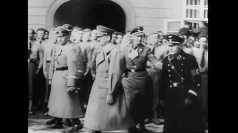 CIRCA 1939 - Adolf Hitler meets with wounded German soldiers in Prague. He and other officials watch a military parade take place in the city.