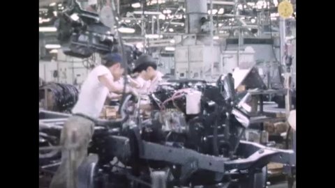 CIRCA 1960s - Workers working quickly on a truck assembly in Japan, 1960s