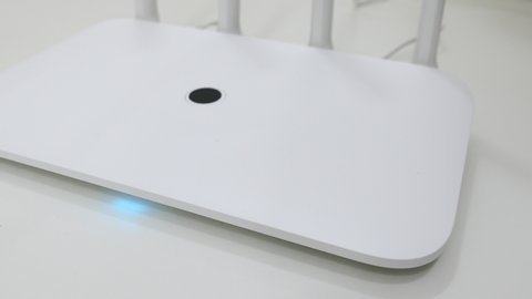 Bokeh White Wireless Wi-Fi Router On The White Desk Panning Slider Shot.