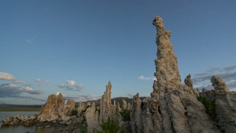 Astro timelapse tracking shot of Milky Way galaxy over tufa formation at Mono Lake, California 