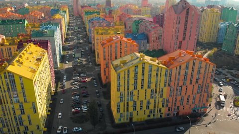 Aerial view of the colorful buildings in european city at sunset. Cityscape with colorful houses, cars on the street. Urban colored landscape. Aerial video of architecture. Aerial view, video footage. Stock-video