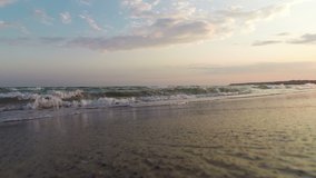 The video shows waves of sea sand and sky