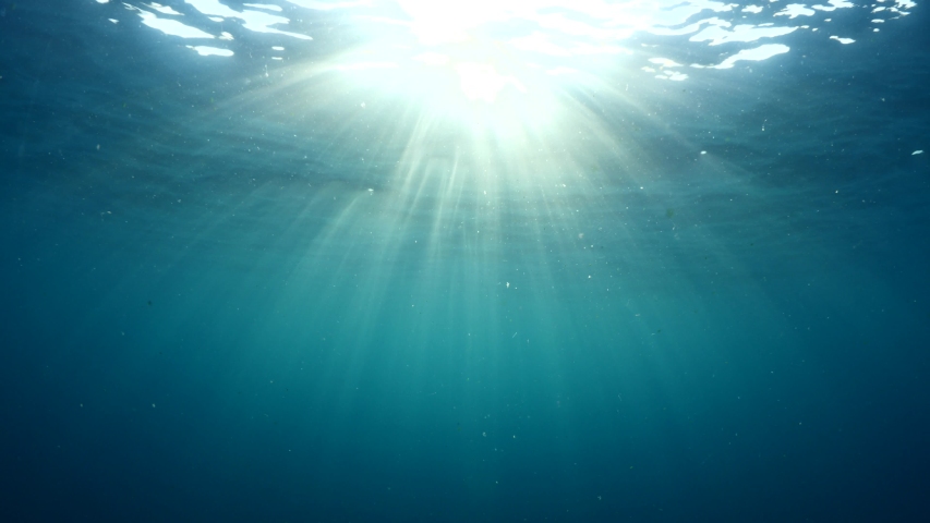 Sun ray and sun beam scenery underwater waves on surface of water slow ocean scenery for backgrounds