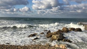 sea landscape video. summer view. rocky beach, sky and waves