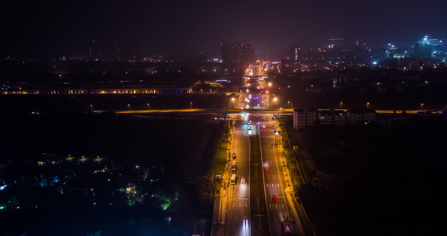 Aerial hyperlapse of an heavy traffic on the road by night in a district of Chengdu, Sichuan China.