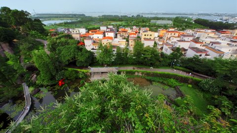 GUANGZHOU, CHINA - MAY 19, 2019: Nice Chinese City View in Summer, Day, Green Trees, Tilt Up