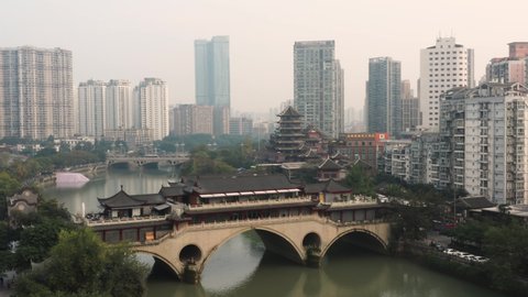 Aerial view of the Anshun Lang Bridge with the Jinjiang river surrounded by lot of buildings in the downtown of Chengdu, China