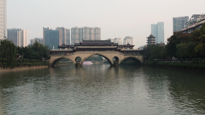 Aerial view of the Anshun Lang Bridge with the Jinjiang river surrounded by lot of buildings in the downtown of Chengdu, China