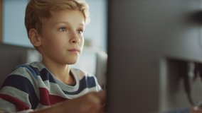 Elementary School Classroom: Smart Boy Uses Personal Computer, Learning How to Use Internet Safely, Programming Language for Software Coding. Schoolchildren Getting Modern Education. Portrait Shot - Powered by Shutterstock - Get 15% off with code: PIKWIZARD15