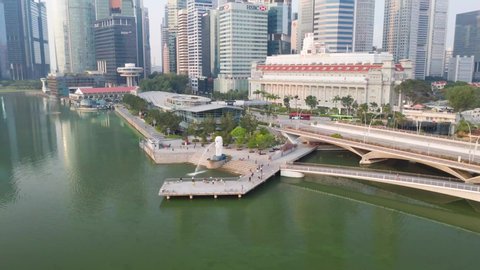 Singapore, Singapore - November 02, 2019: Hyperlapse of merlion fountain in front of financial buildings at downtown of Singapore.