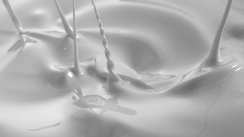White Paint Drops Splashing in Slow Motion with Swirl Macro Shot  | Shutterstock HD Video #1040546363