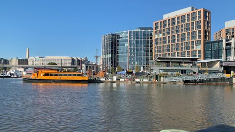 Washington, DC / US - November 06, 2019: A view of the yellow Potomac river water taxi boat vessel docked and picking up passengers at The Wharf station pier in southwest waterfront pier