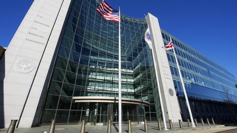 Washington DC, USA - January 13, 2018: US United States Securities and Exchange Commission SEC entrance with cinemagraph loop of American flags