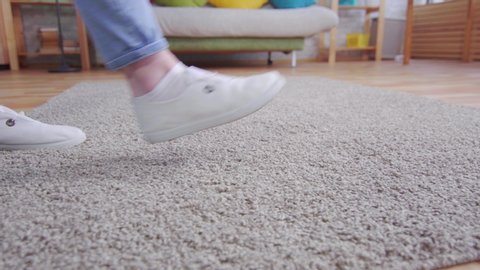 young woman walks across the carpet and leaves a dirty trail