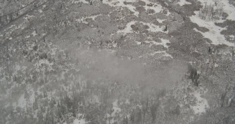 Aerial helicopter shot, push up and over a tundra covered mountainside to reveal another mountain, drone footage