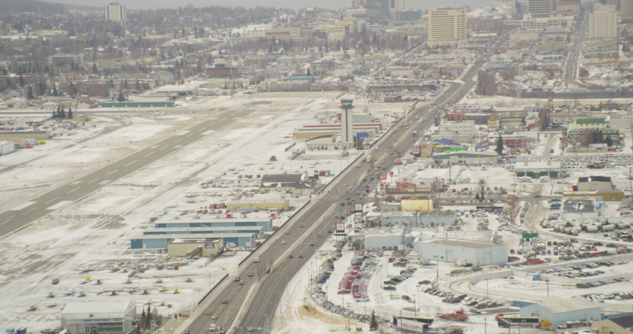 Aerial closeup helicopter shot, tracking down highway towards skyscrapers in city by the bay, drone footage