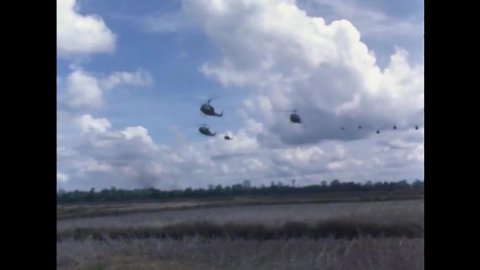 CIRCA 1966 - UH-1E Huey helicopters land in Vietnam.