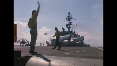 CIRCA 1967 - Crew move an RA-5C onto a catapult, the console operator launches it. A C-2A lands on deck, of the USS Constellation.