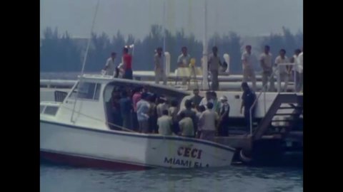 CIRCA 1980s - A boat carrying Cuban refugees is shown docking at a marina in Florida.