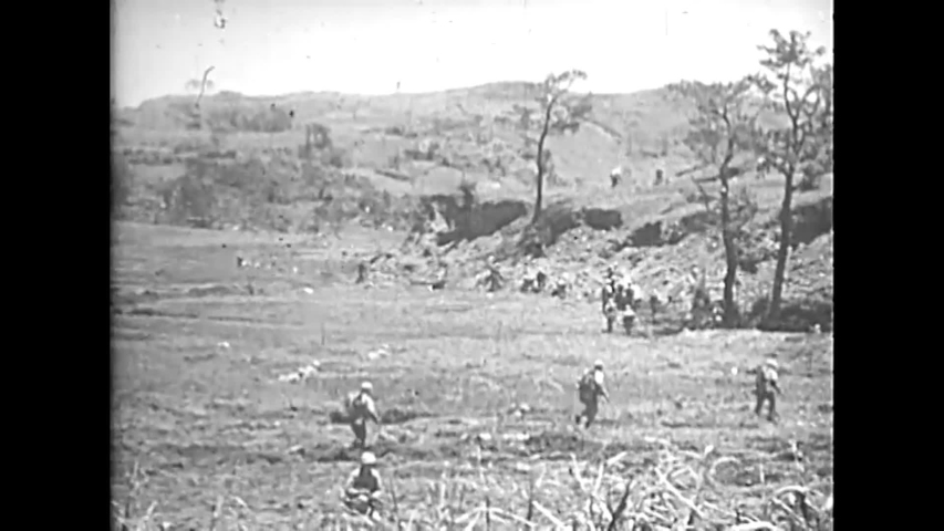 CIRCA 1945 - US Marines advance on foot and in tanks across Naha.