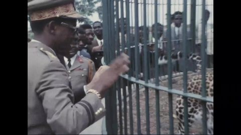 CIRCA 1971 - The Apollo 11 astronauts and local military officers look at a caged leopard in Kinshasa.