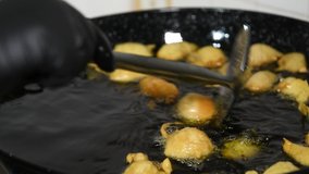 Frying Pettole - Typical dish of South of Italy. Pettole is a traditional christmas south italian food cooked from dough and fried in olive oil, made in Salento, Puglia