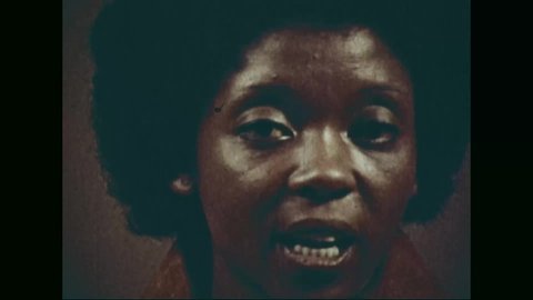 CIRCA 1973 - A Kenyan woman contextualizes propaganda against the Land Freedom Army during the Mau Mau Uprising.
