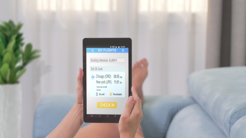 Woman lying on couch check in online on tablet app | Shutterstock HD Video #1040589869