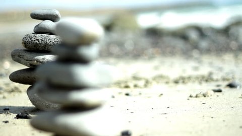 Zen stones on a beach, dolly shot