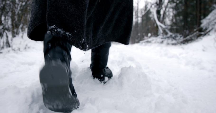 Male Clad In Black Walking Away From Camera On Snowy Path Royalty-Free Stock Footage #1040605313