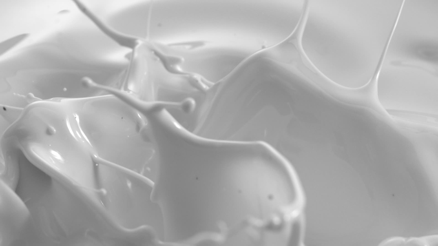 White Liquid Paint or Milk Fluid Splashing with Drops and Curves in Slow Motion  | Shutterstock HD Video #1040605835