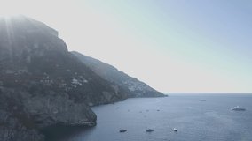 Aerial footage drone view of  boat and ship in front of Positano, in Amalfi coast Naples Italy // no video editing