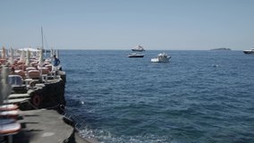 Aerial footage drone view of  boat and ship in front of Positano, in Amalfi coast Naples Italy // no video editing
