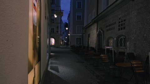 Salzburg, Austria – October 11, 2019: Shopping street at night with people in Salzburg.