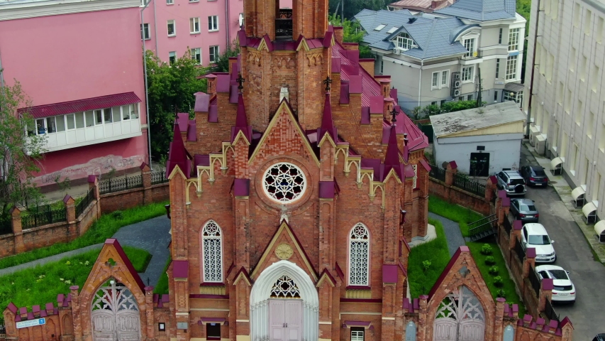 Irkutsk, Siberia, Russia. Aerial view of the Polish Church(Catholic Church), surrounded by green park zone and city buildings. Taken by drone at sunny summer day 