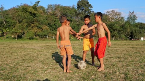 Rural Kids Soccer Team In Group Huddle