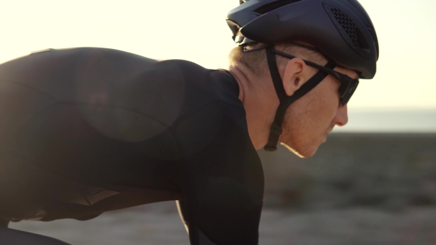 Cyclist Professional Fit Man On Triathlon Bicycle.Triathlete Training On Bike.Cycling Exercise On Bike.Cyclist Rider In Helmet And Sportswear Riding Workout At Sunset On Triathlon Time Trial Bicycle | Shutterstock HD Video #1040632391