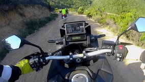 Speedometer and motorcycle steering wheel. road adventure going forward along a broken road at high speed. Field and forest trail. Off-road motorcycle. enduro. Biker and lifestyle. POV motorcycle