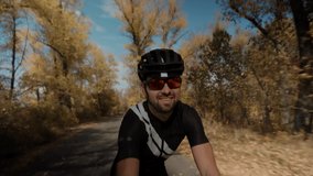 Cyclist Taking Selfie Video When Riding On Bicycle.Close Up Cyclist In Motion On Trail Road.Gravel Cycling On Countryside Road Twists Pedals And Riding.Intensive Workout Pedaling On Gravel Bicycle.